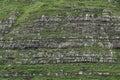 Erosion lines of stratified sedimentary rocks in steep mountainside