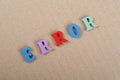 ERROR word on paper background composed from colorful abc alphabet block wooden letters, copy space for ad text Royalty Free Stock Photo