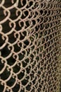 Erspective view of a rusty and dirty chained fence in the park - Old braided wire wall used for protection Ã¢â¬â Rough textured