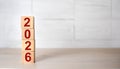 ertical Stack of Wooden Blocks with Red Numbers Forming the Year 2026 Royalty Free Stock Photo