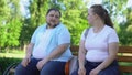 Erudite obese man telling interesting stories to pretty girl, self-confidence
