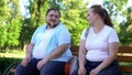 Erudite obese man telling interesting stories to pretty girl, self-confidence Royalty Free Stock Photo