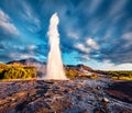 Erupting of the Great Geysir lies in Haukadalur valley on the slopes of Laugarfjall hill.