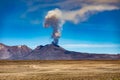 The eruption of the active volcano Sabancaya on 09/20/2022 with an ash plume in the blue sky near the town of Chivay in the Colca