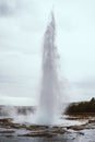The eruption of the famous Strokkur Geyser In Iceland on cold cloudy afternoon Royalty Free Stock Photo