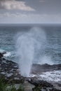 Eruption of the Spouting Horn under cloudscape in Koloa, Kauai, Hawaii, USA Royalty Free Stock Photo