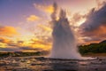 Eruption of Strokkur geyser in Iceland at sunset Royalty Free Stock Photo