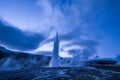 Eruption of Strokkur geyser in Iceland. Winter cold colors, moon lighting through night