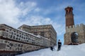 Erzurum Castle , Clock tower , winter . Children sliding in the snow.