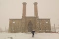 Erzurum, Turkey during snow storm. Twin Minaret school. Islamic ancient building