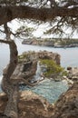 Es Pontas in Mallorca with boat anchored nearby in the Mediterranean sea. Majorca Sunrise with yacht and rock arch near Santanyi.