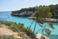 Es Pontas in Mallorca with boat anchored nearby in the Mediterranean sea. Majorca Sunrise with yacht and rock arch near Santanyi.