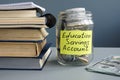 ESA Education Saving Account label on jar with money and books