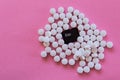 Esc or scape key of a computer keyboard covered by white pills isolated on pink background. Pop photography, concept of addiction Royalty Free Stock Photo