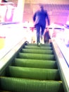 Escalator and blurry man in movement