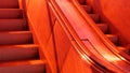 Escalator with bright red lighting, stairs, red light exterior moving staircase detail, closeup, nobody, no people