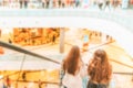 Escalator people blurred background. Interior of retail centre store in soft focus. People shopping in modern commercial mall Royalty Free Stock Photo