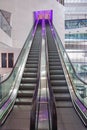 Escalator with purple illumination in modern office building