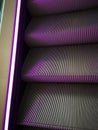 Escalator with purple neon lights