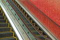 Escalator and red tiled wall