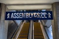 Escalators and sign leading to the Assembly Food Hall, a famous food court in downtown