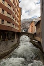 River Valira on Engordany Bridge and houses view in a snowfall day in small town Escaldes-Engordany in Andorra on January 16, 201