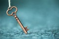 Escape room concept. Vintage key on blue background with copy space