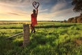 Escape to the Country - female on fence with love heart in morning light