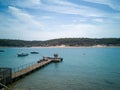 Summer Paradise: Boats Dot Serene Seascape with Golden Sunset & Sandy Beach