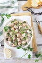 Escargots, traditional French cuisine: snails with sauce Burgundy and baguette