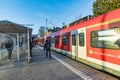 people waiting outside at the trai platform of the S-Bahn, the public transportation system in Frankfurt for the metro