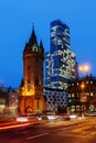 Eschenheimer Turm in front of the Nextower at the Eschenheimer Tor square at night, Frankfurt, Germany