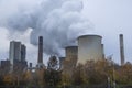 Steam clouds rising from cooling towers of power station. Royalty Free Stock Photo