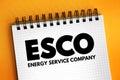 ESCO - Energy Service Company acronym text on notepad, abbreviation concept background