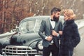 Escort of girl by security. Couple in love on romantic date. Bearded man and sexy woman in fur coat. Retro collection Royalty Free Stock Photo