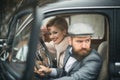 Escort of girl by security. escort concept with bearded driver and luxury girl in retro car.