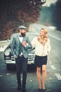 Escort of girl by security. escort concept with bearded driver and luxury girl in retro car.