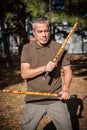 Escrima and kapap instructor demonstrates sticks fighting techniques in park Royalty Free Stock Photo