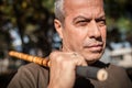 Escrima and kapap instructor demonstrates sticks fighting techniques in park