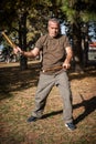 Escrima and kapap instructor demonstrates sticks fighting techniques in park