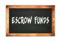 ESCROW FUNDS text written on wooden frame school blackboard