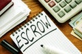 Escrow handwritten on a page by marker