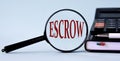 ESCROW - word on magnifying glass on a light background with calculator, notepad and pen