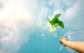 ESG and Clean Energy Concept. Hand Raise up a Wind Turbine Paper into the Sky. Decrease Carbon and Produce a Green Power. World Royalty Free Stock Photo