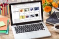 Online shop website design template on a laptop monitor, office desk background