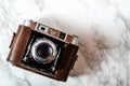 Antique Camera with Leather Holster on Marble Background