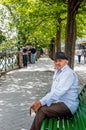 Old man in casual clothings resting on the bench