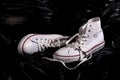 White Converse Sneakers on Black Background