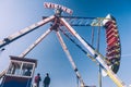 Side view of Viking Funfair Ride in Amusement Park under Clear Blue Sky