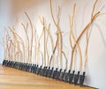 Group of shovels with handles made of curved tree branches leaning to the wall in Odunpazari Modern Museum